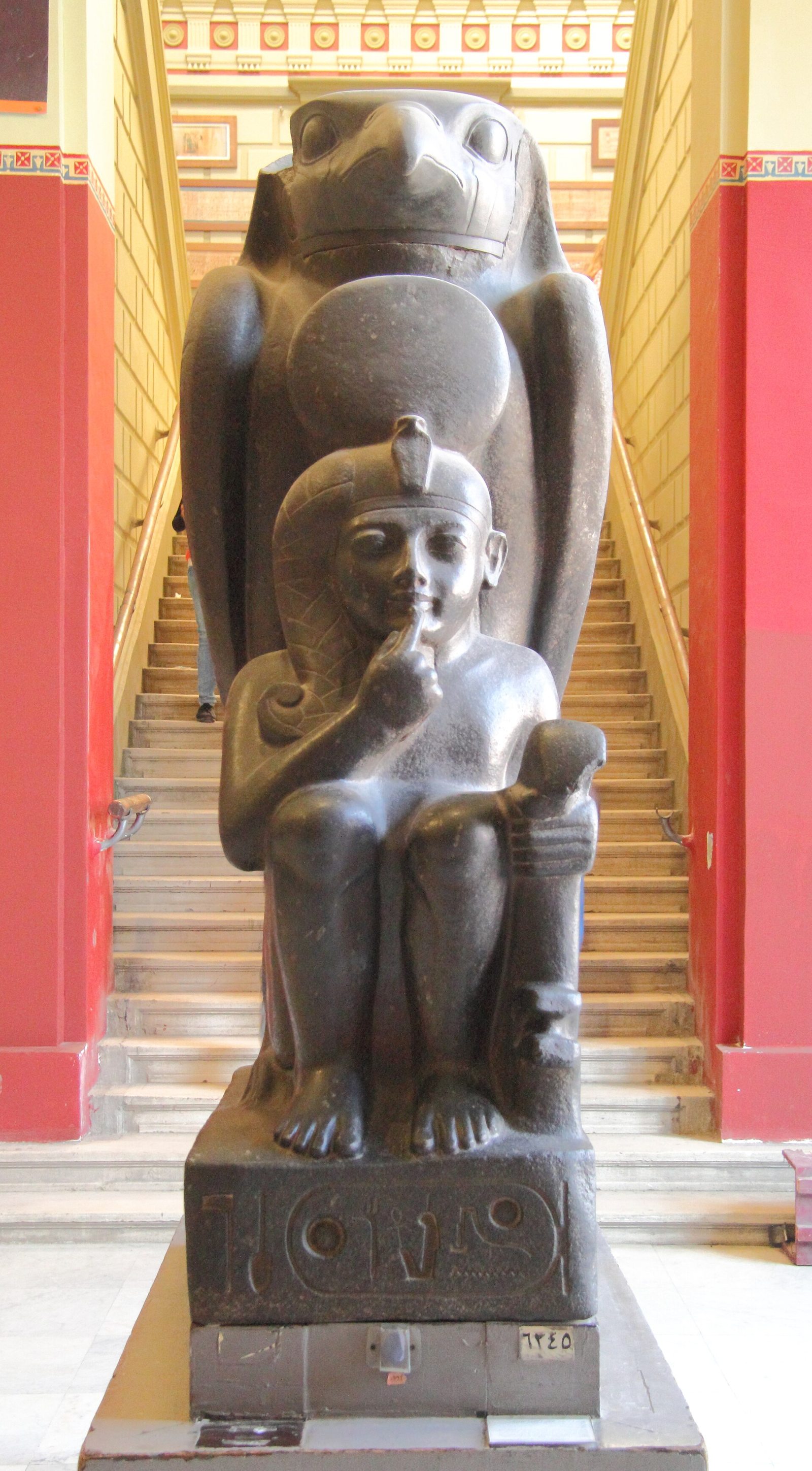 Falcon form beside a royal figure in the Egyptian Museum in Cairo